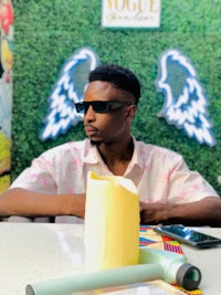 a man wearing sunglasses sitting at a table